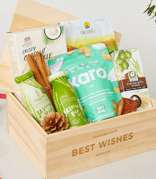 Deluxe gourmet gift box with Thai specialty foods, jasmine rice, coconut treats, and cashews in natural timber packaging