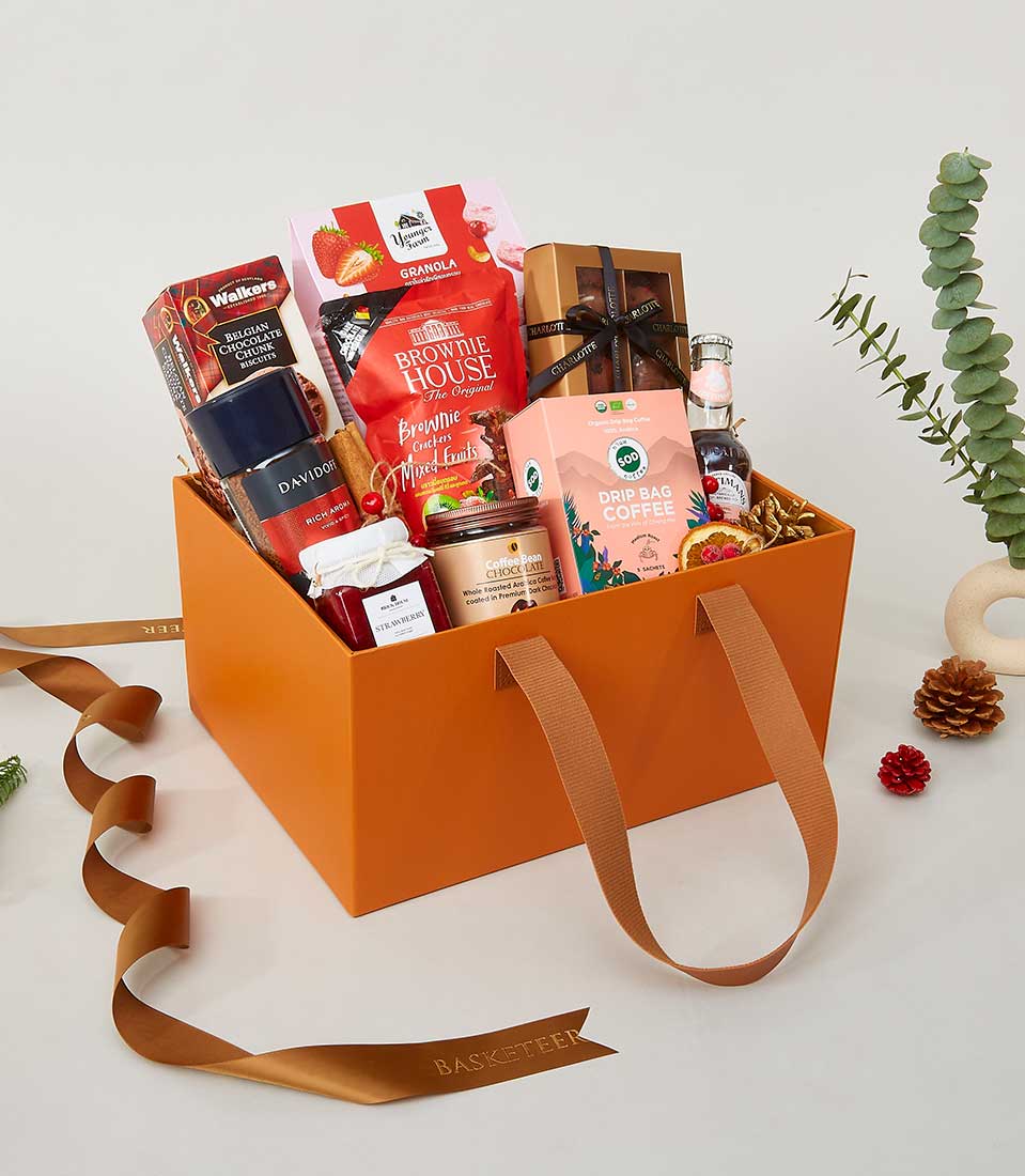 Orange leather carryall gourmet gift box with crackers, coffee, jam, and chocolate for New Year gifting