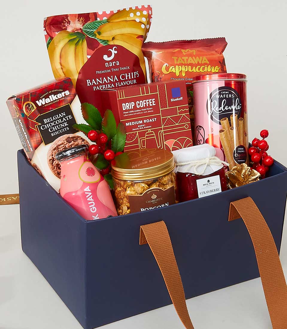 Navy blue leather-handled gift box with gourmet snacks, coffee, jam, and chocolates for New Year gifting