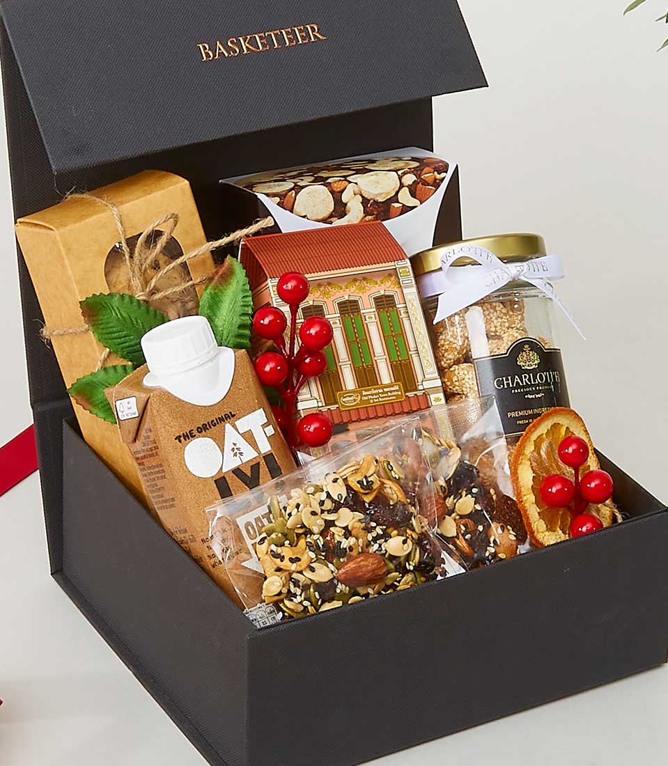 Luxury wellness snack assortment box with oat milk, artisan cookies, and mixed nuts for New Year gifting