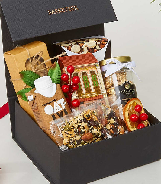 Luxury wellness snack assortment box with oat milk, artisan cookies, and mixed nuts for New Year gifting