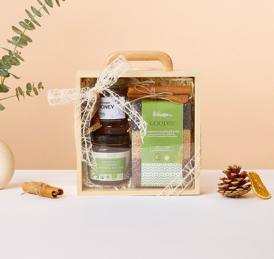 Premium wellness gift box with honey, coconut nectar, and organic rice grains, tied with cream ribbon