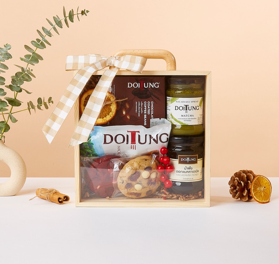 Wooden gift box with gourmet wellness treats, matcha spread, macadamia honey, chocolate coffee beans, and pastries