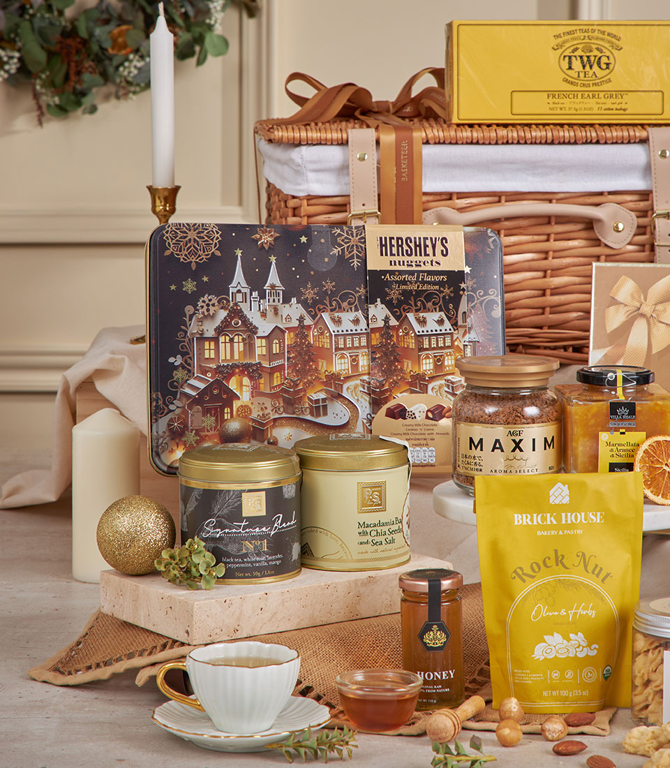 Luxury gourmet New Year hamper with premium chocolates, specialty teas, coffee, honey, and artisan treats in wicker basket