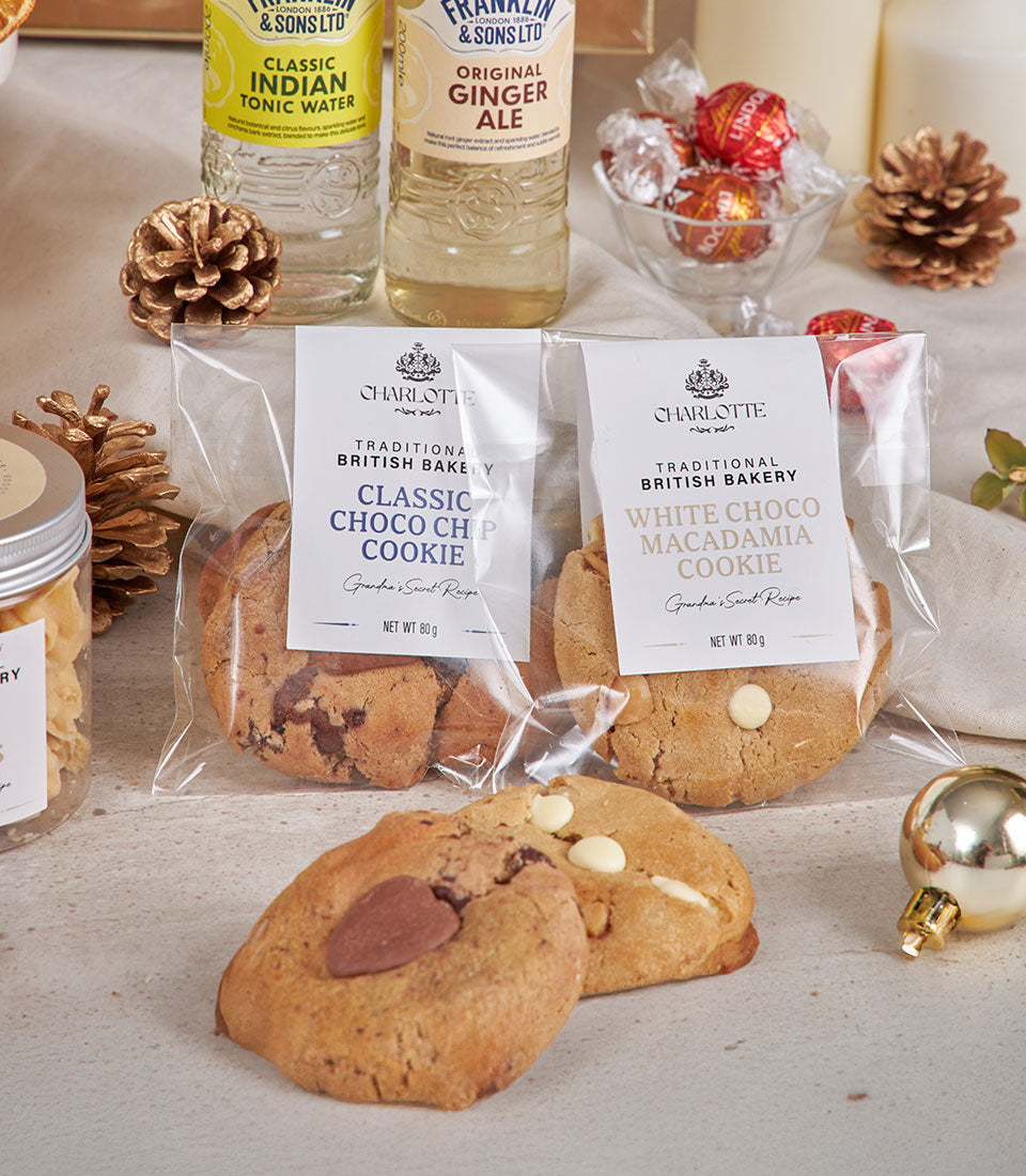 Luxury gourmet celebration hamper with artisan cookies, premium tonic water, ginger ale, and festive gold accents for New