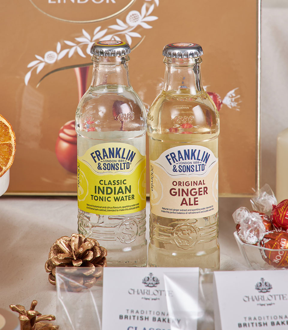 Luxury New Year gourmet hamper with Franklin & Sons beverages, Charlotte bakery treats, Lindor chocolates, and golden gift
