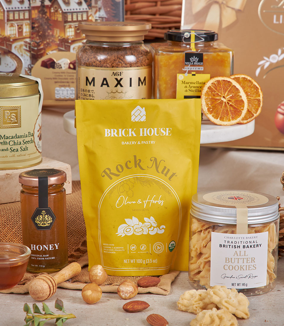 Luxury gourmet New Year gift hamper with mixed nuts, honey, British butter cookies, coffee, and marmalade on rustic burlap
