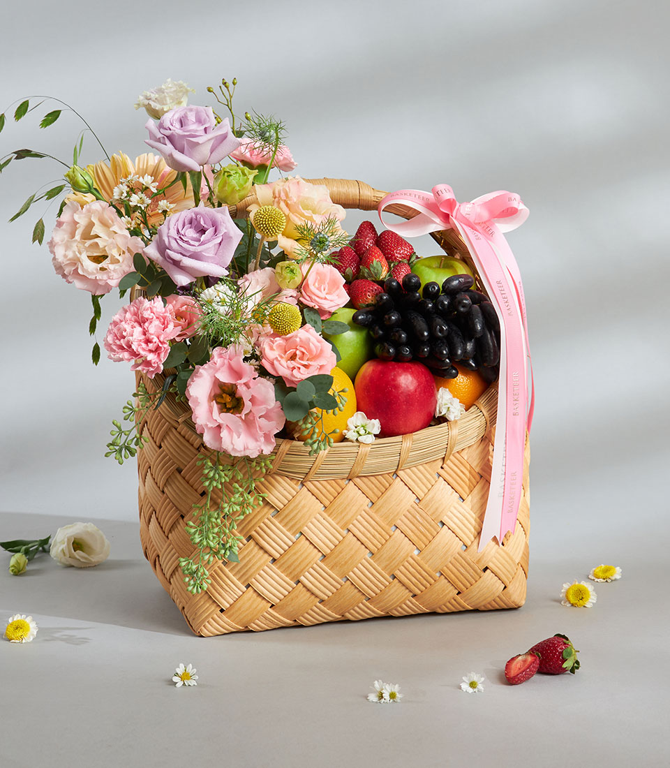 Premium fruit basket with pastel roses, carnations, and fresh apples, grapes, strawberries for birthday gifts