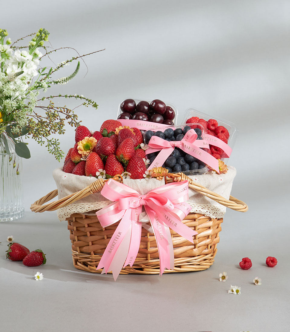 Premium fresh berry basket with strawberries, blueberries, and raspberries in wicker hamper