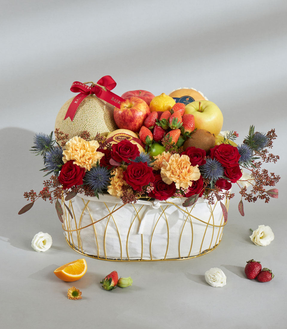 Luxury red and gold fruit floral basket with fresh roses, cantaloupe, and strawberries for birthday gifting