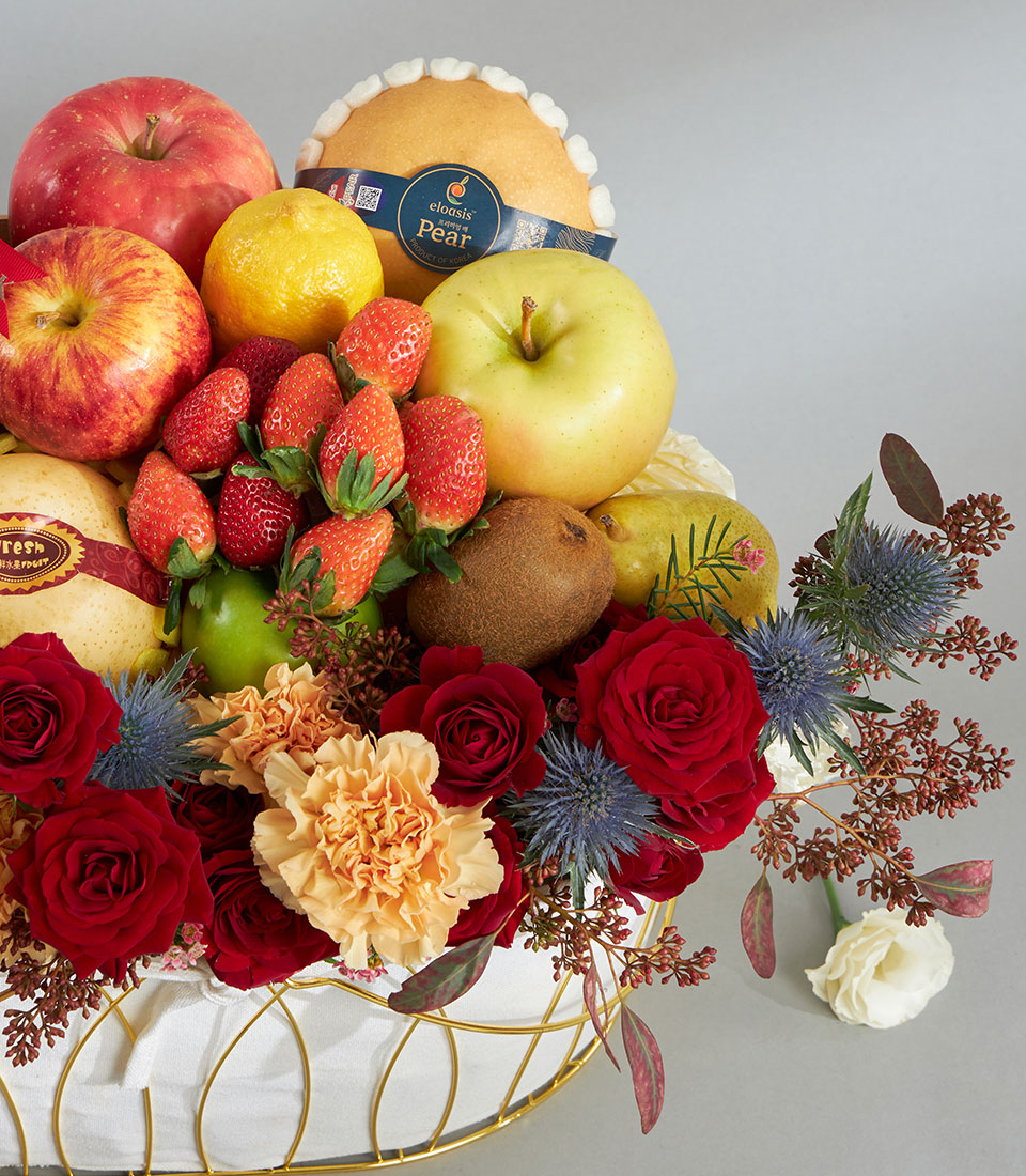 Luxury red and gold fruit floral basket with fresh apples, pears, strawberries, and vibrant roses for birthday gifting