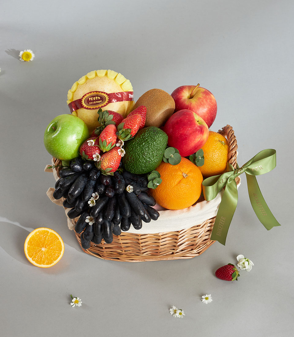 Premium woven fruit basket with Moon Drop grapes, apples, oranges, and imported selection