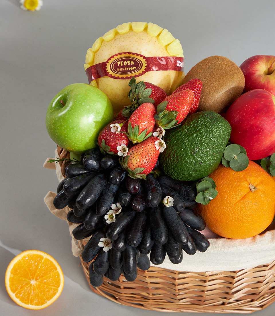 Premium woven fruit basket with moon drop grapes, pears, apples, strawberries, and imported fresh produce selection