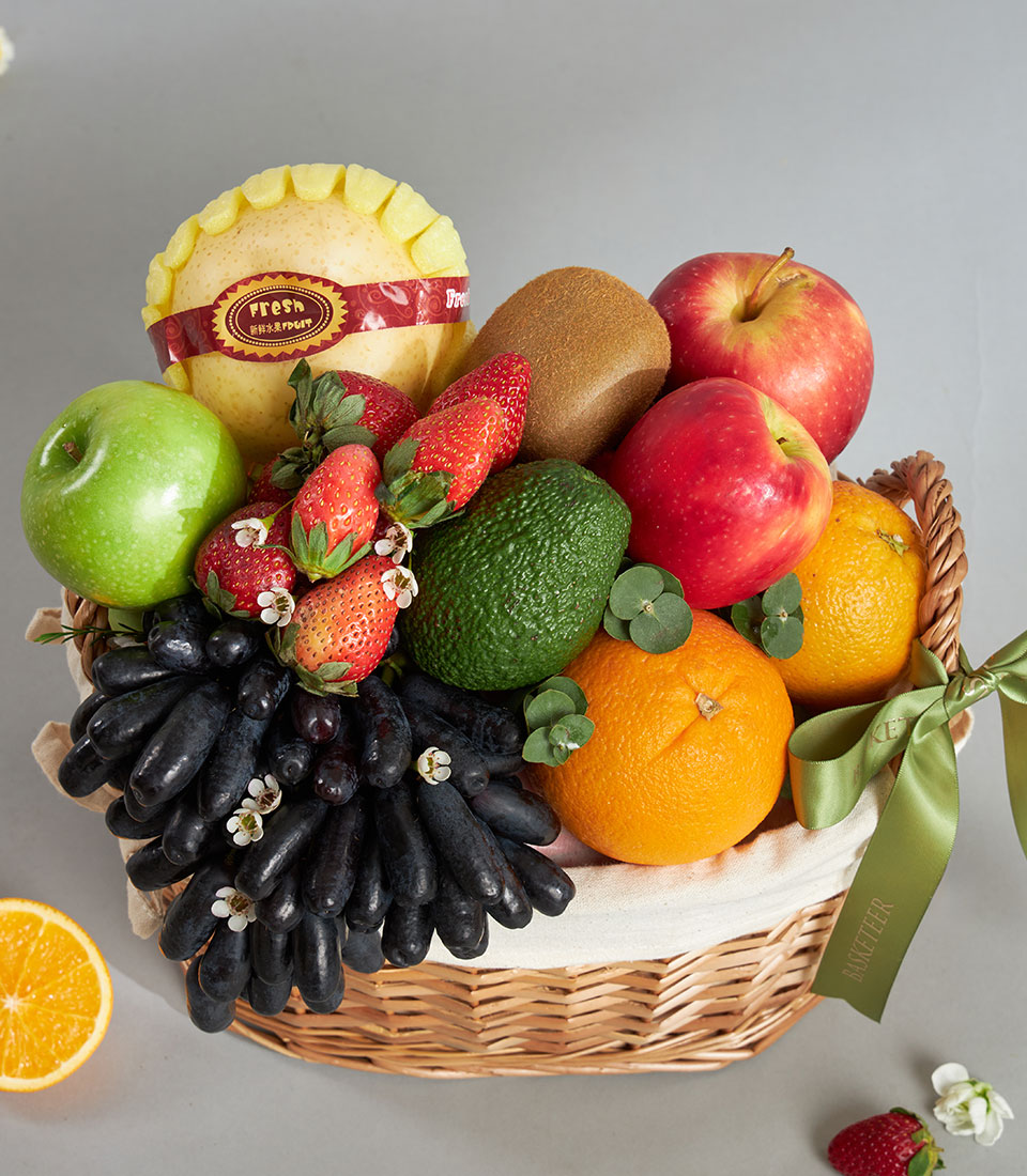 Premium wicker fruit basket with Moon Drop grapes, pears, apples, oranges, kiwi and strawberries, cream fabric lining