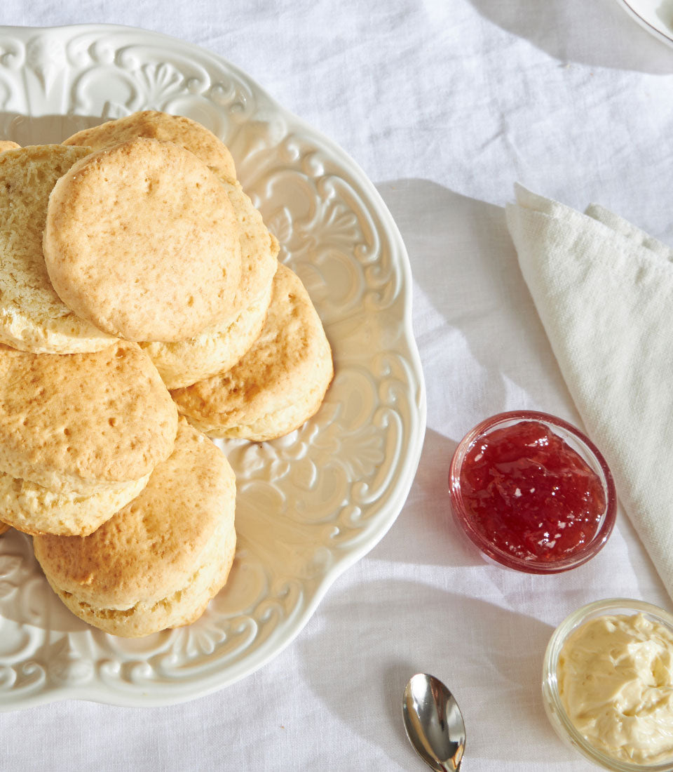 Golden-brown British scones with strawberry jam and clotted cream, afternoon tea gift set