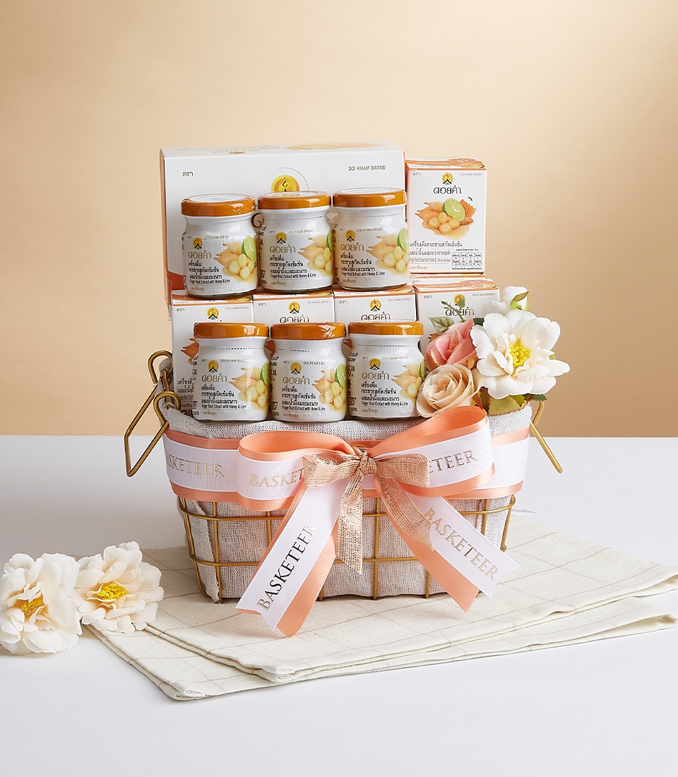 Doi Kham turmeric extract wellness gift basket with glass jars, peach ribbon, and artisan packaging