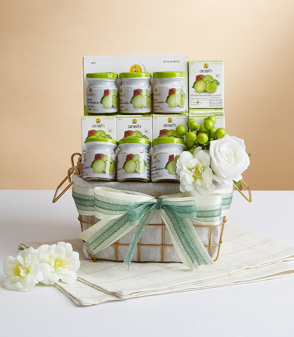 Luxury gold wire gift basket with Doi Kham Triphala Extract jars, guava wellness products, and cream ribbon bow