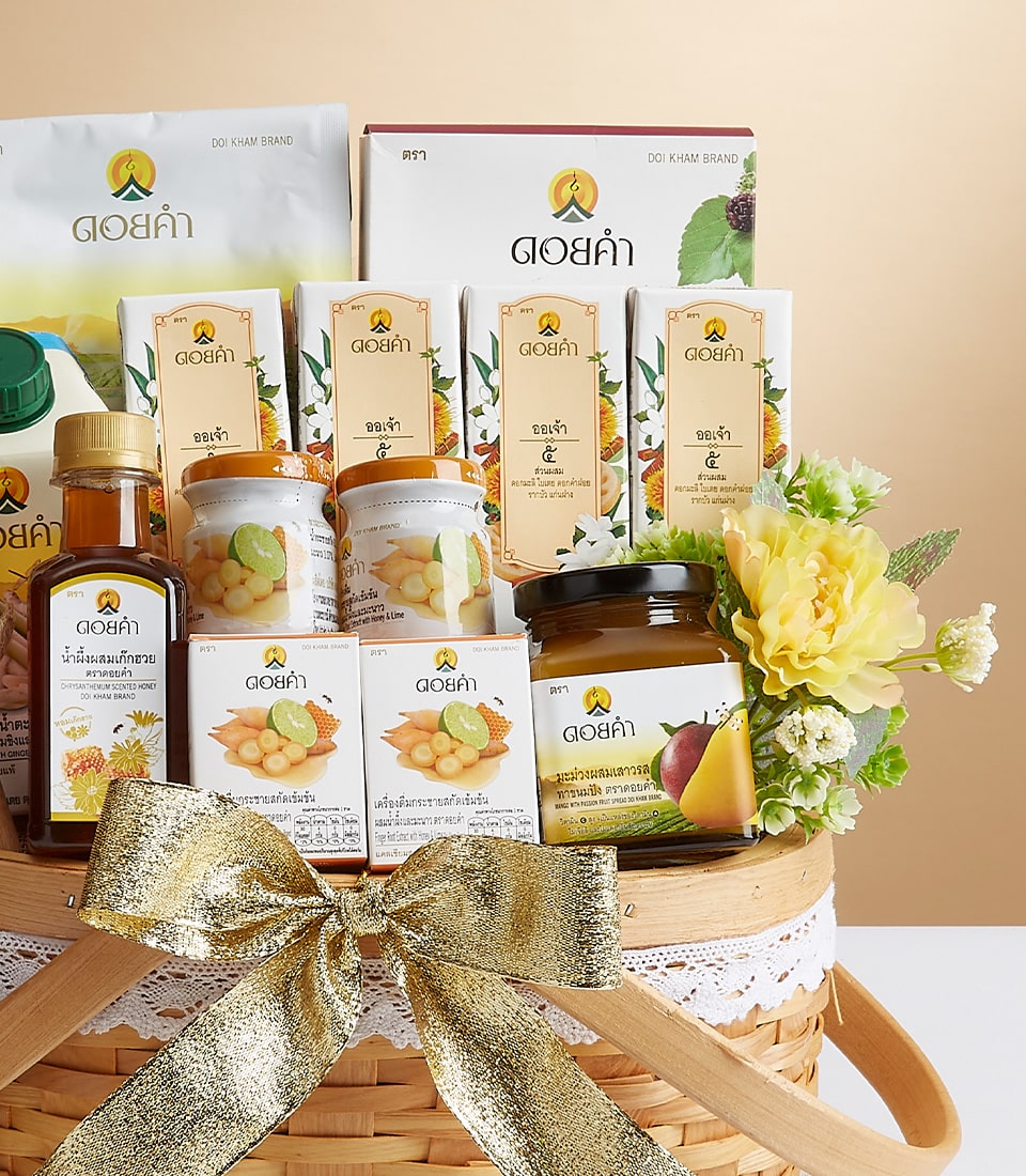 Elegant woven gift basket with Doi Kham wellness essentials, honey, herbal teas, and fruit preserves tied with gold ribbon