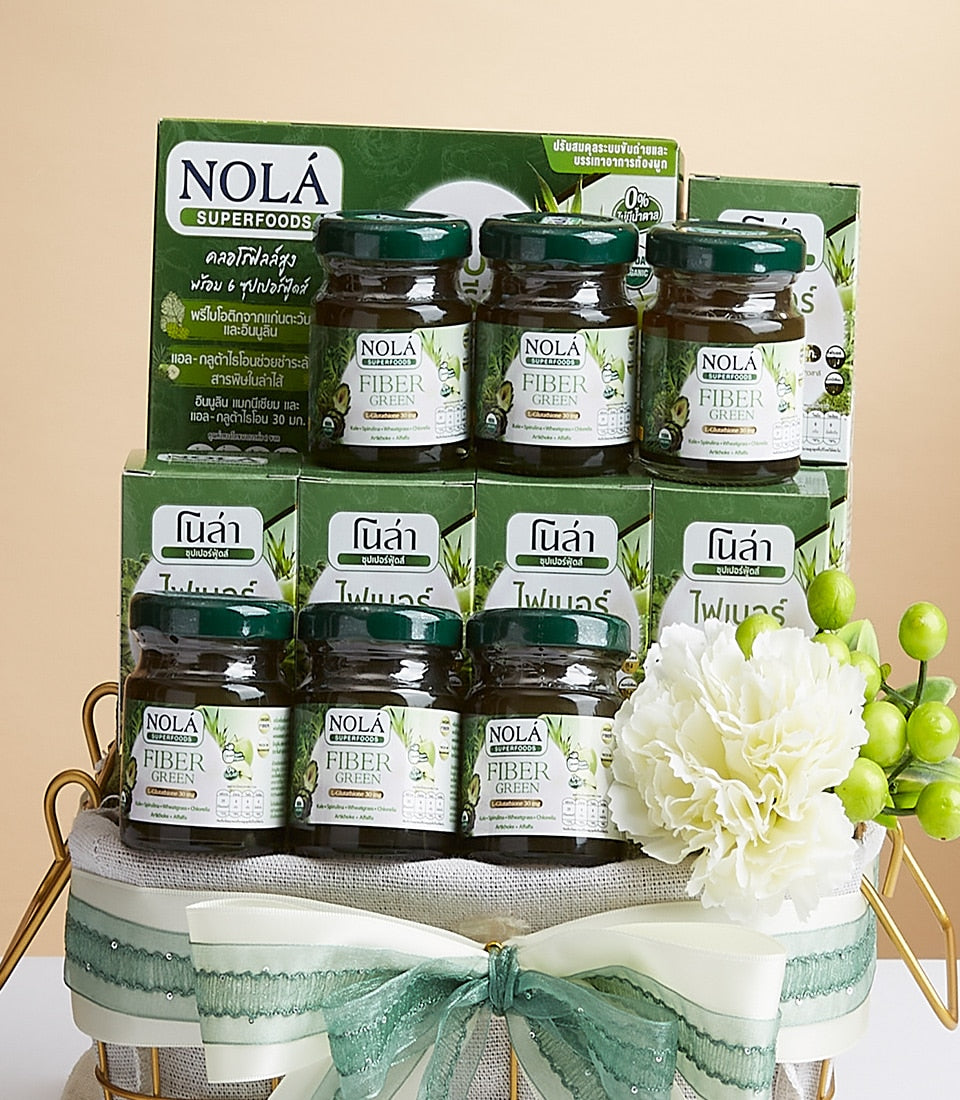 Premium green superfood fiber gift basket with twelve NOLA jars, gold wire basket, white carnation, and sheer green ribbon