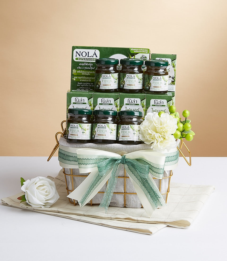 Gold wire mesh gift basket with NOLA Fiber Green superfoods jars, green boxes, and cream ribbon bow