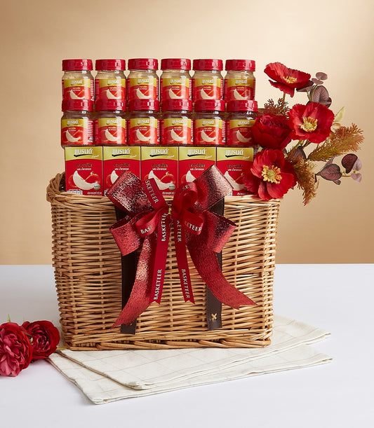 Luxury gift basket with bird's nest jars, premium boxes, and red poppies in woven wicker with leather handles