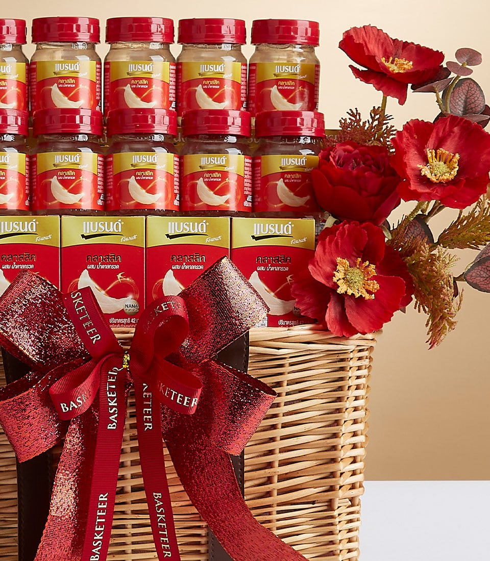 Premium red and gold gift basket with bird's nest health products, wicker weave, and artificial red flowers