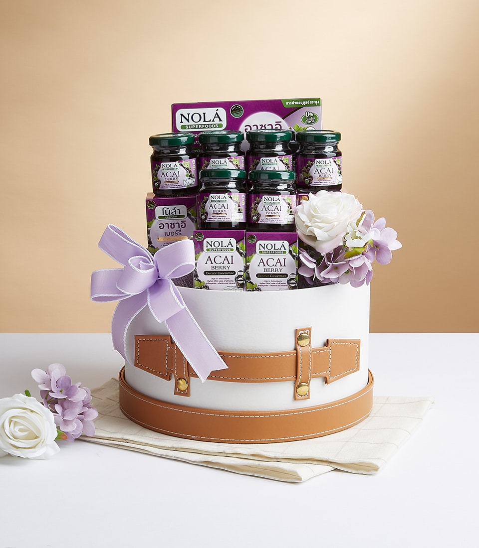 NOLA Acai Berry superfood gift box with purple flowers and studded leather strap