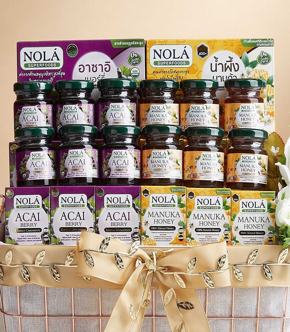 Nola Eclectic superfood gift basket with acai berry and manuka honey jars in rose gold wire basket with gold ribbon