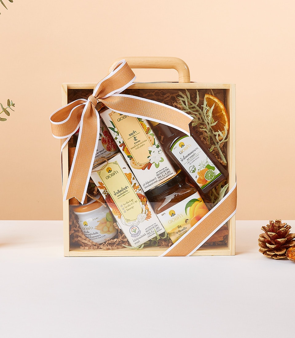 Harmony Wellness gift collection in clear wooden box with natural dried botanicals and artisan wellness products