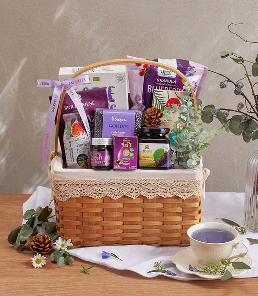 Premium blueberry and superfood wellness gift basket with granola, black rice, fig juice, and health supplements in woven