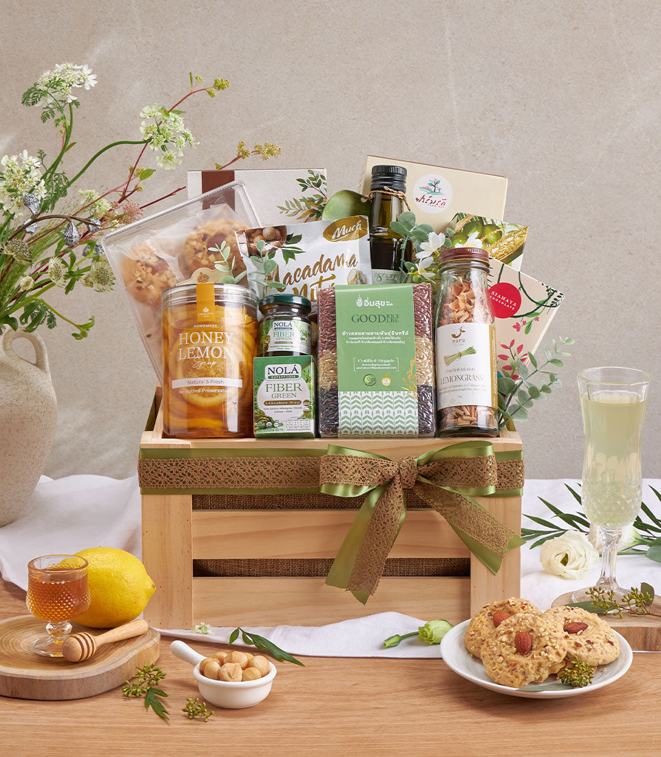 Organic health and wellness gift basket with honey, lemongrass tea, fiber snacks, and premium oils in rustic wooden crate