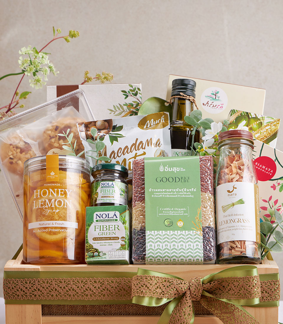 Organic wellness gift hamper with pad thai rice, olive oil, honey lemon syrup, superfoods, and Thai herbs in wooden crate