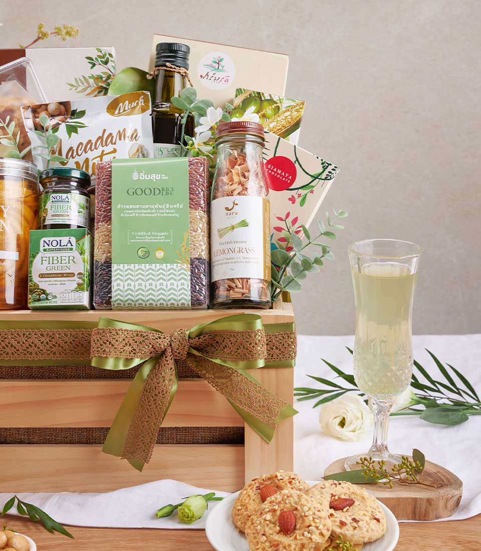 Premium organic wellness hamper with Pad Thai rice, macadamia nuts, olive oil and herbal infusions in wooden crate