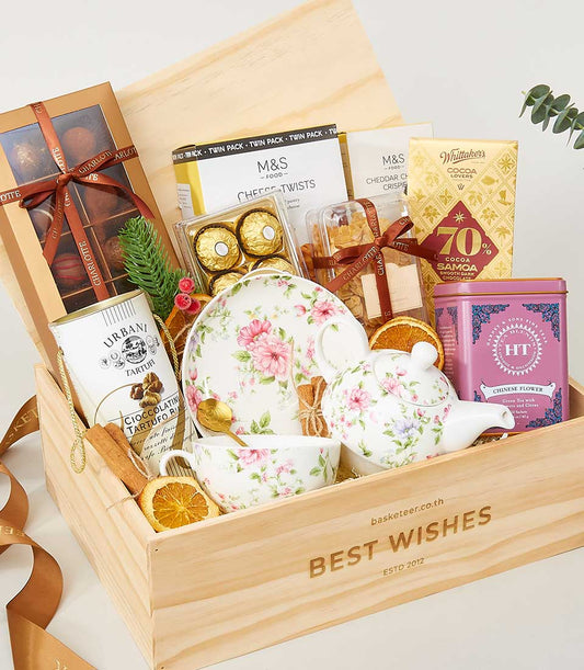 Globetrotter's Gastronomy wooden crate with macarons, truffles, chocolates, cheese twists, dark chocolate, and floral tea