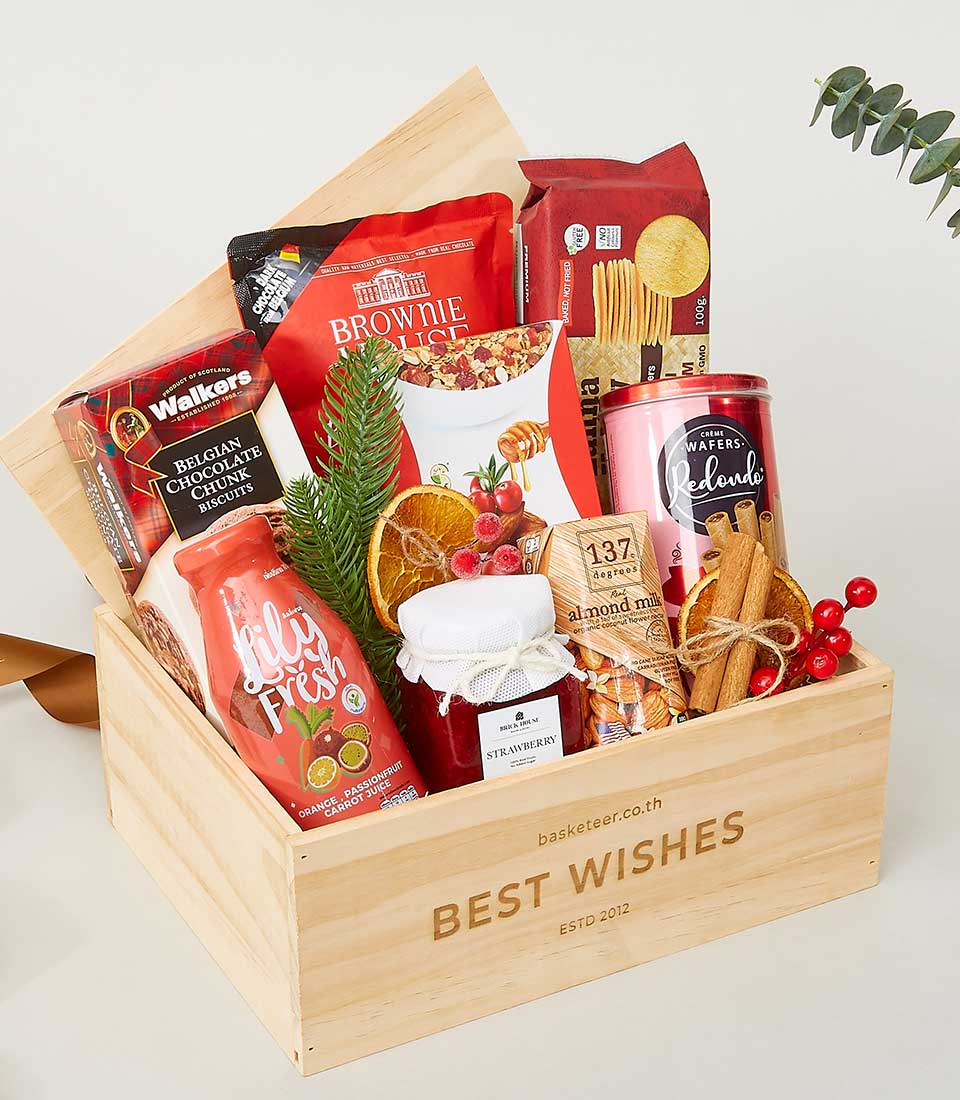 Wooden gift crate filled with gourmet chocolates, biscuits, jam, juice, and artisan snacks for New Year celebrations