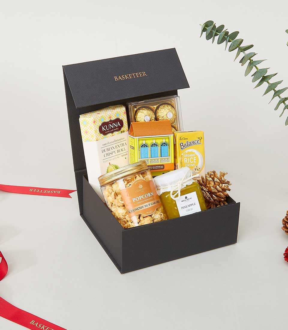 Luxury New Year gift box with durian crisps, caramel popcorn, pineapple spread, rice drink, and gold chocolates