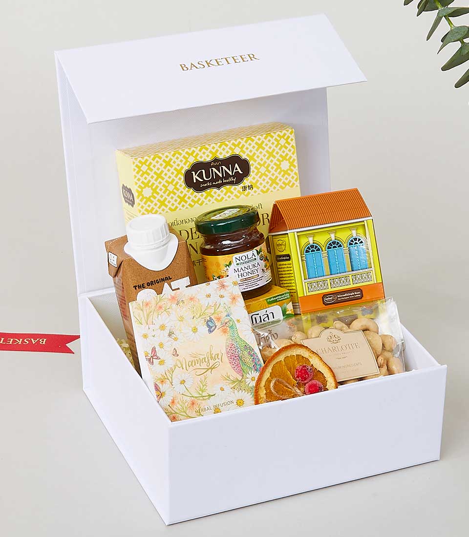 Luxury gourmet gift basket with honey, healthy snacks, and herbal tea for New Year celebrations