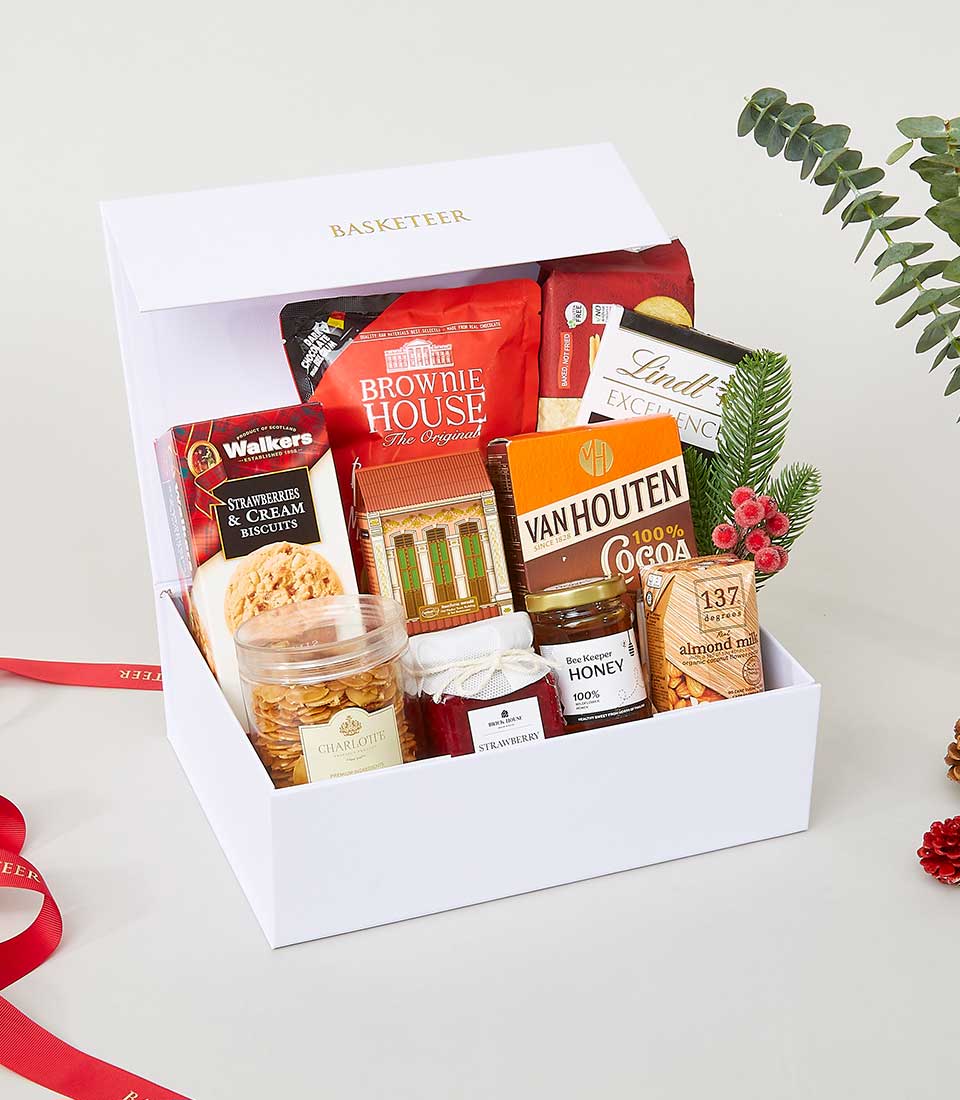 White luxury gift box with gourmet treats, brownie mix, biscuits, honey, and jam for New Year gifting