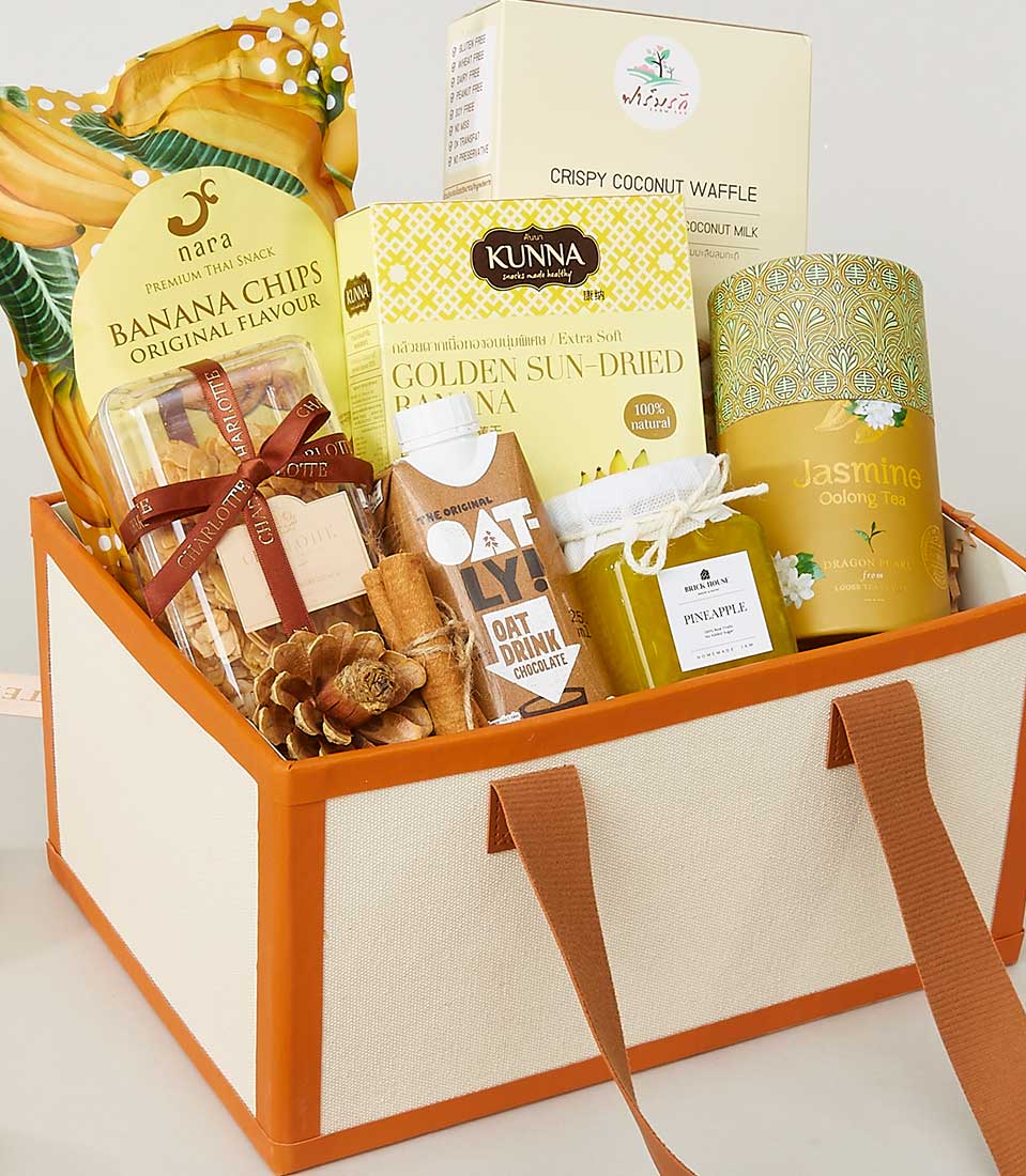 Luxury New Year gift basket with gourmet treats, banana chips, Charlotte cookies, dried fruit, and Thai jasmine oolong tea