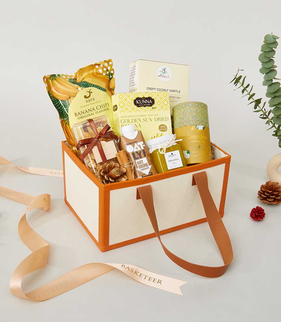 Premium New Year gourmet gift box with banana chips, coconut waffle, oolong tea, and artisan snacks