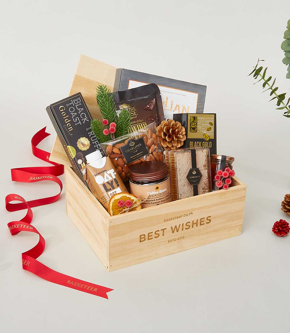 Wooden New Year gift box with gourmet treats including black truffle toast, almonds, oat milk, coffee chocolate, and