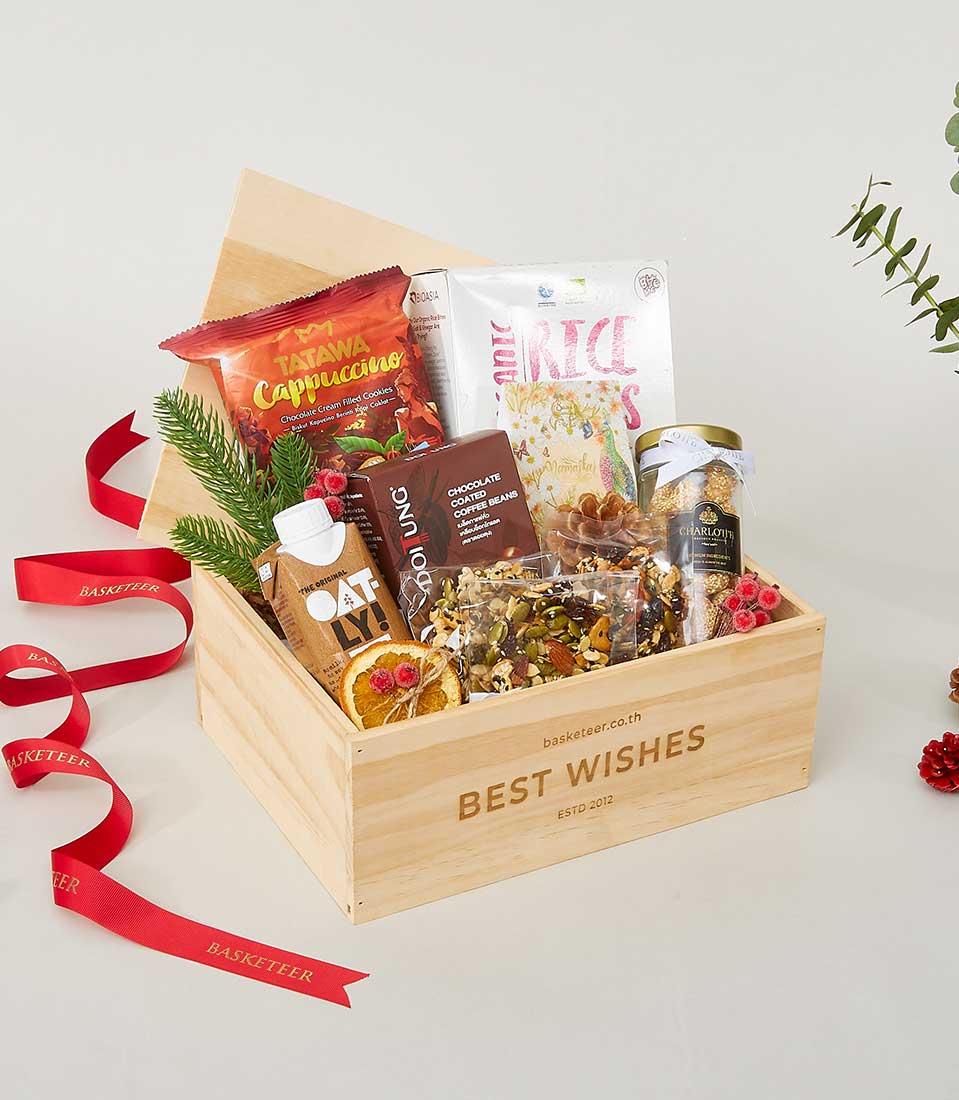 Wooden gourmet gift box with artisan coffee, organic rice, chocolate, nuts and festive holiday decorations