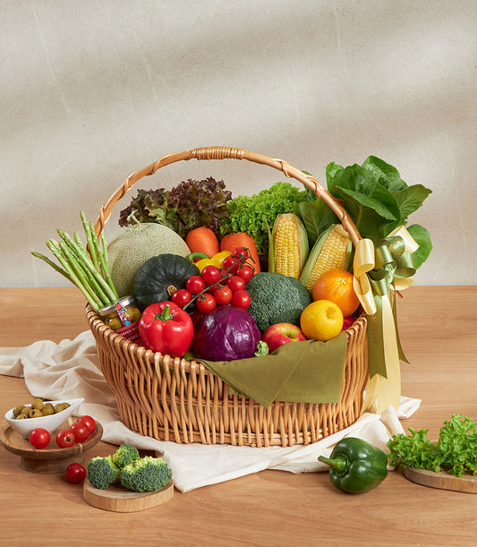 Premium vegetable and gourmet gift basket with fresh asparagus, peppers, broccoli, and seasonal produce in wicker