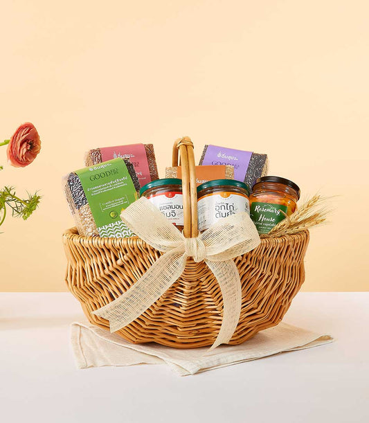 Wicker gift basket with gourmet rice, pickled vegetables, and artisan sauces tied with burlap bow for New Year