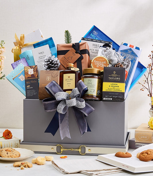 Luxury grey gift hamper with dark blue and silver ribbon bow, filled with gourmet chocolates, honey, coffee, tea, and