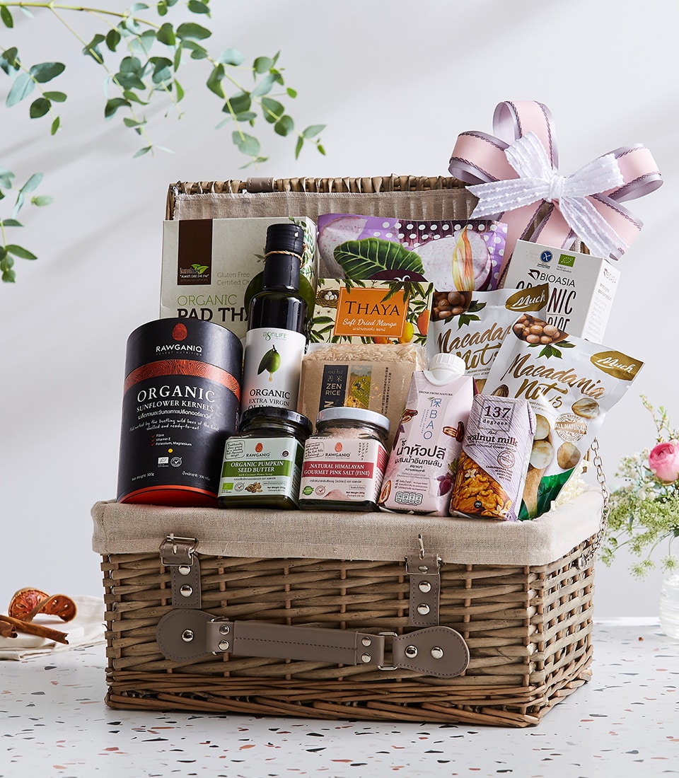 Premium wicker hamper filled with organic Thai gourmet foods, sunflower kernels, olive oil, and dried mango with pink ribbon