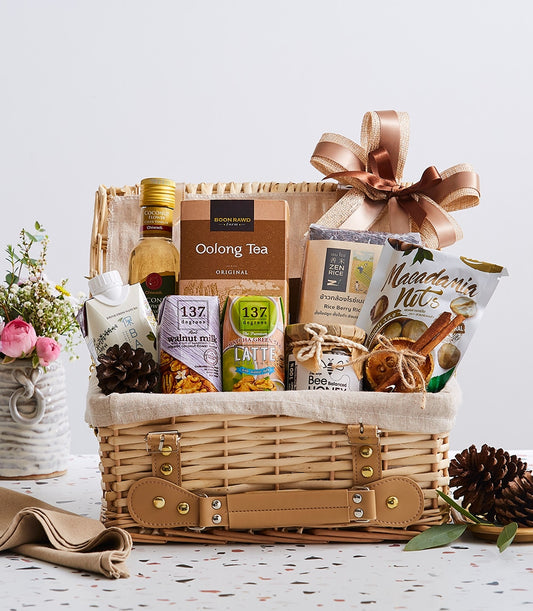 Flavors of Thailand wicker gift basket with coconut syrup, oolong tea, plant-based milk, macadamia nuts, honey, and dried