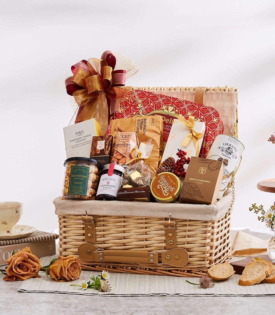 Luxury wicker gift basket filled with gourmet treats, burgundy ribbon bow, perfect for premium gifting