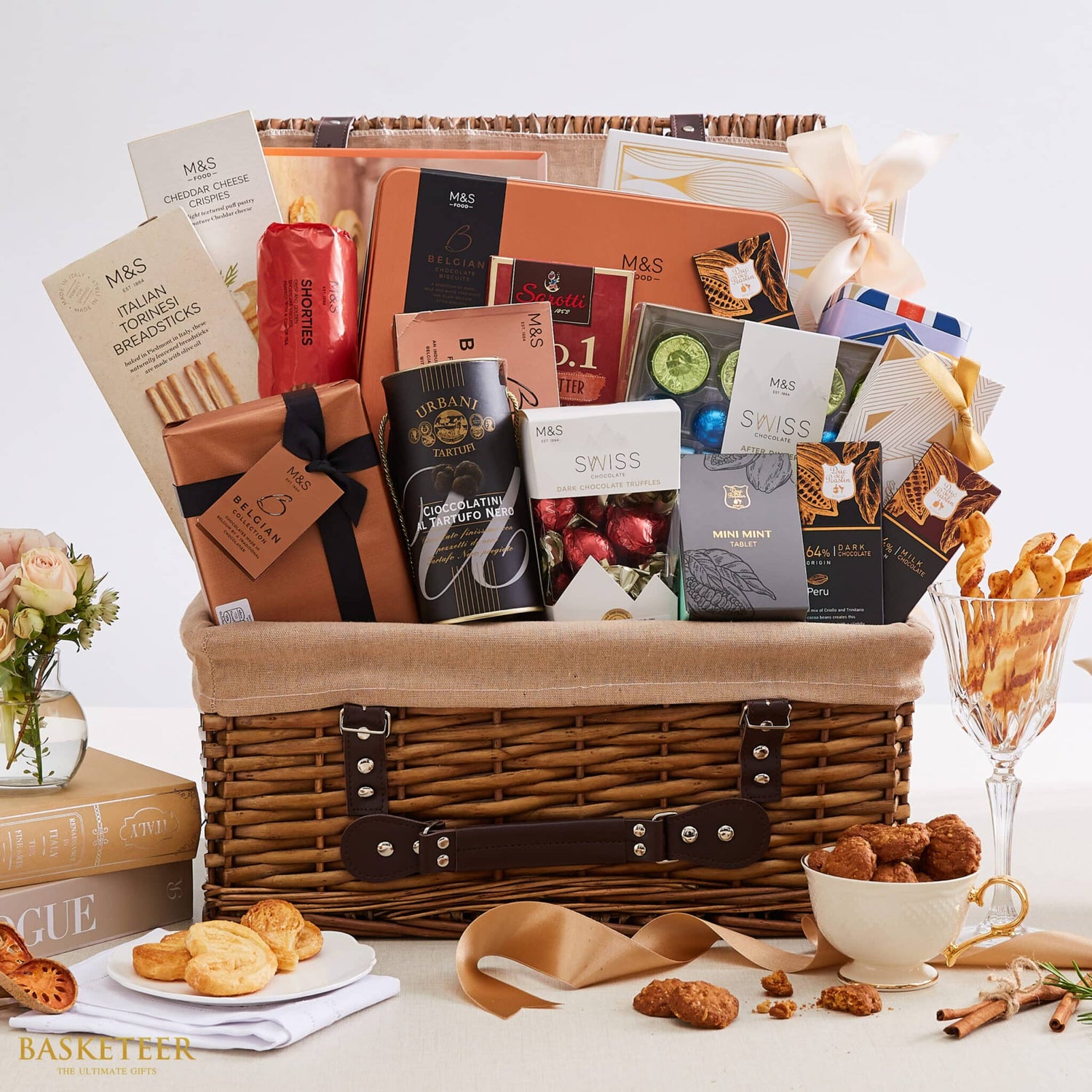 Luxury woven wicker hamper filled with gourmet chocolates, cheeses, biscuits, and artisan treats