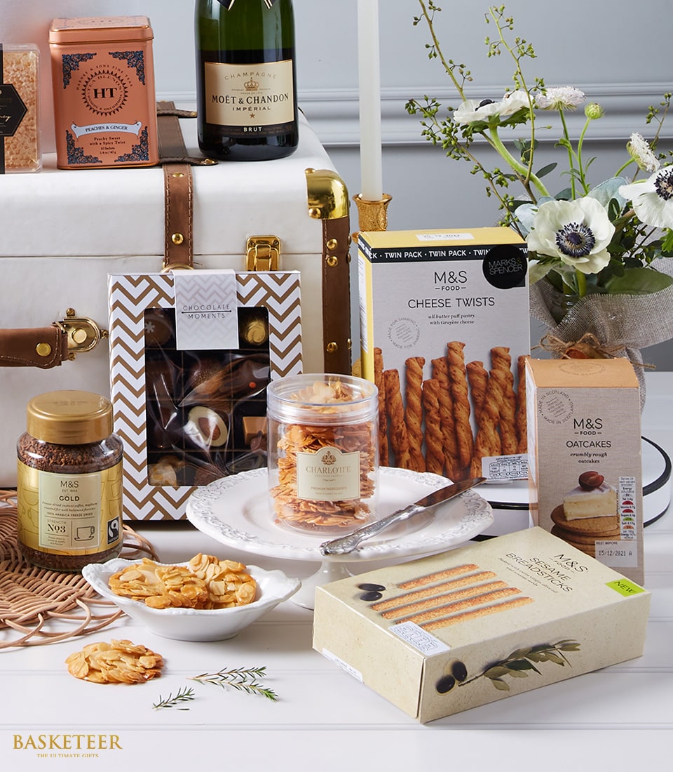 Luxurious champagne gourmet hamper with chocolates, gourmet foods, premium coffee, candle and white anemones